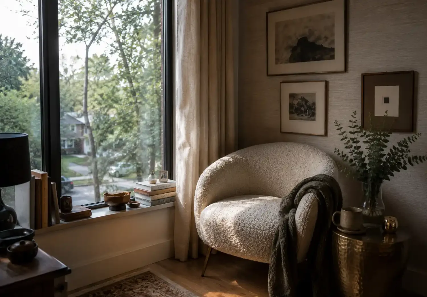 Bedroom corner with boucle accent chair and gold legs, styled as functional furniture that adds texture, balance, and purpose. 