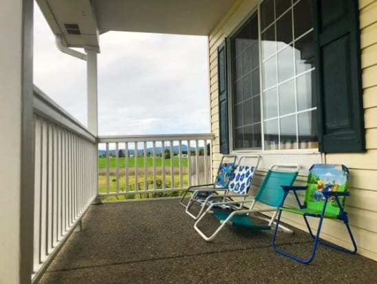 Summer porch decor with simple folding chairs and mountain views showing small front porch potential.