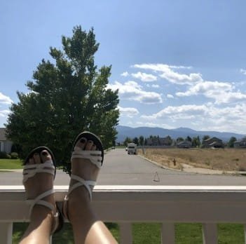 Feet in sandals with scenic view