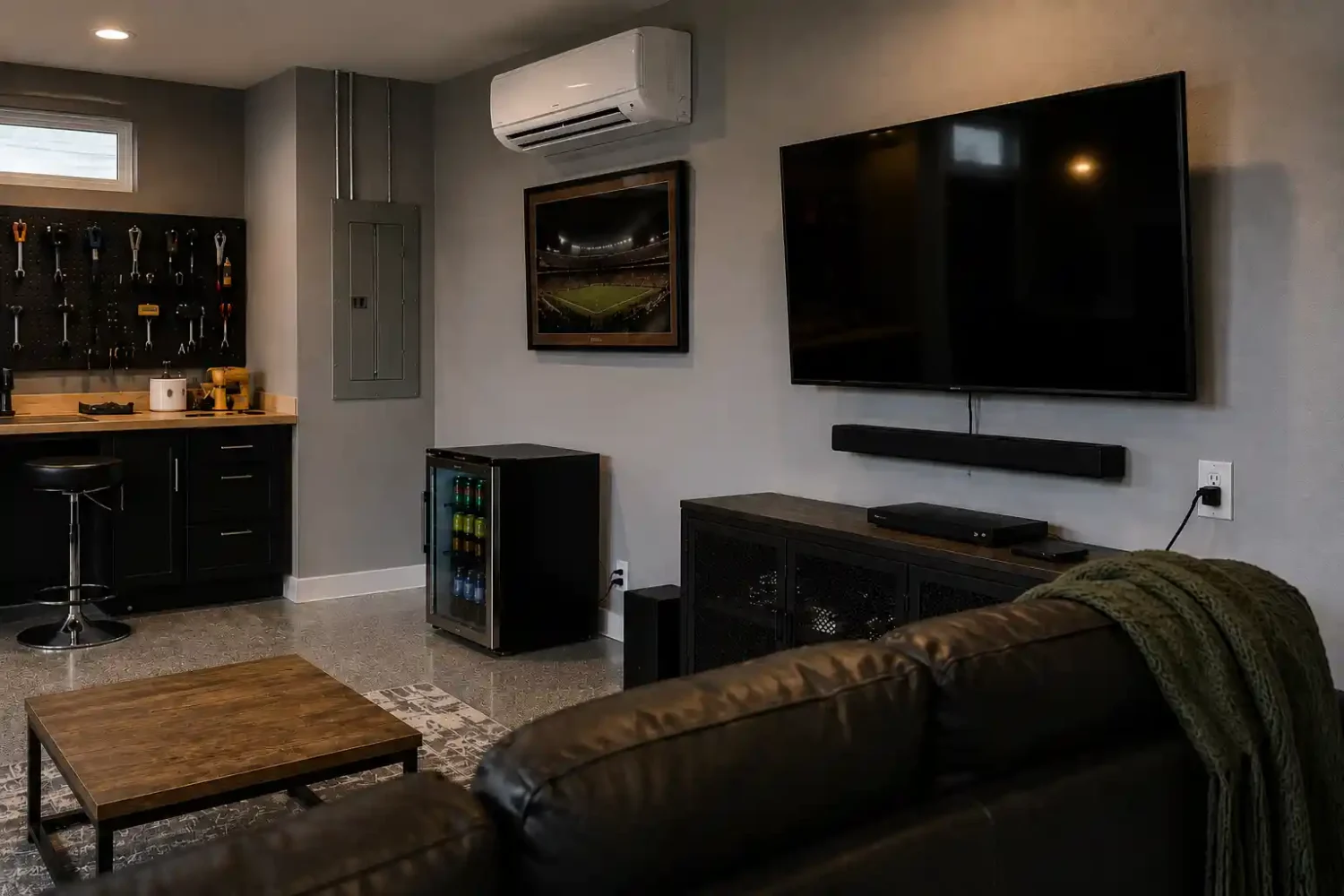 The outlet by the mini fridge is too high. In a real garage, that receptacle would usually be 12 to 18 inches above the finished floor (measured to the center of the box). The fridge cord would disappear behind the appliance instead of stretching upward.
The outlet on the far right wall is also higher than normal. Standard receptacles are generally low on the wall unless they're intentionally placed higher for a workbench or specialty equipment.