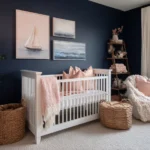 A nautical nursery with deep navy walls, a white crib, and coastal-inspired decor. The room is styled with blush and coral accents, rope storage baskets, and ocean-themed artwork, creating a modern and versatile baby room design.