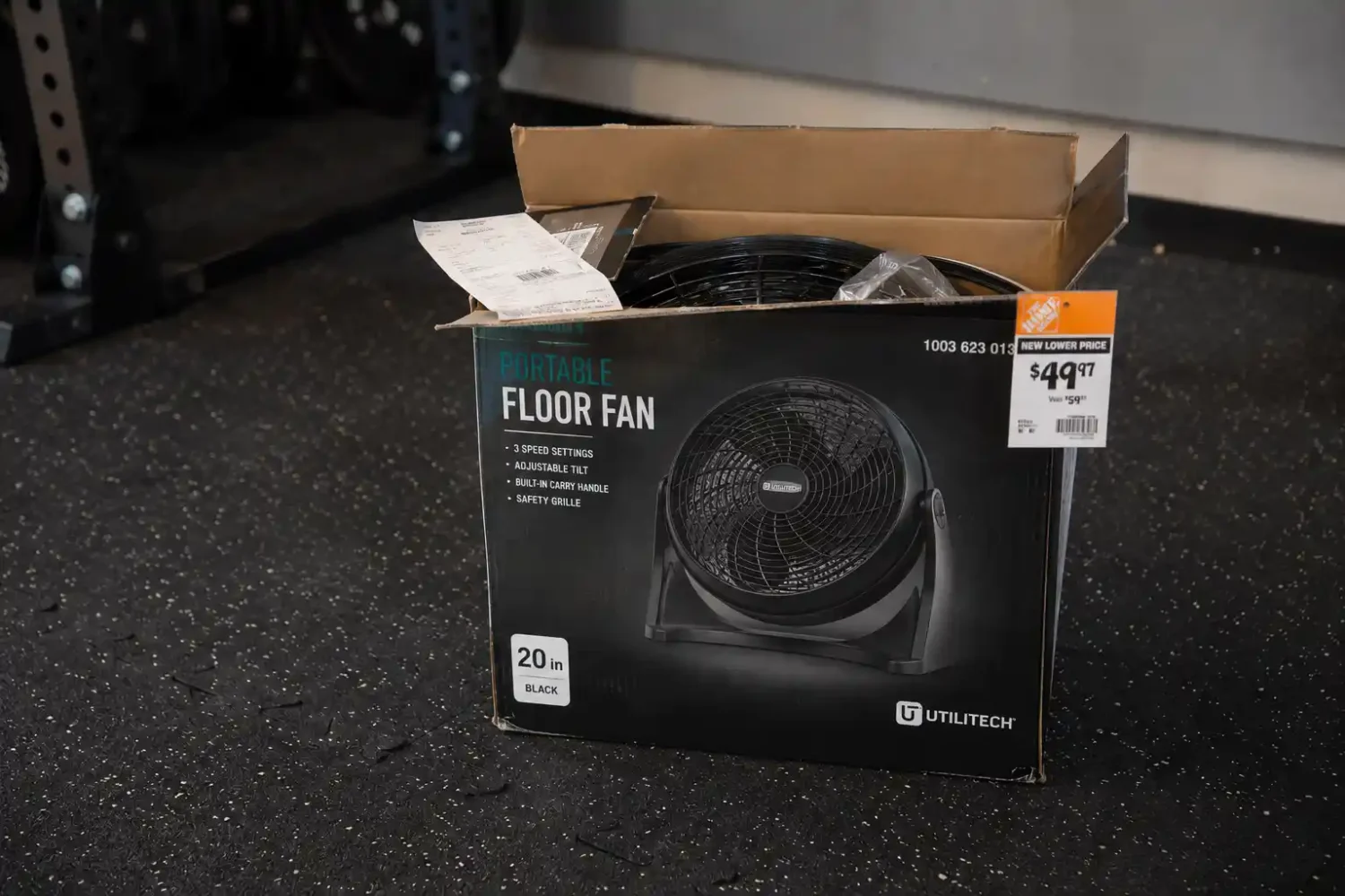 Garage fan ideas starting under fifty dollars with a portable floor fan box on rubber gym flooring next to a power rack.